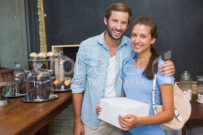 Young happy couple smiling at the camera