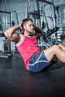 Muscular man doing sit-ups