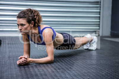 Muscular woman doing push-ups