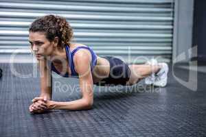 Muscular woman doing push-ups