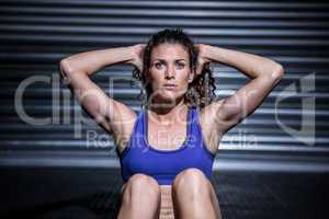 Muscular woman doing sit-ups