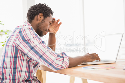 Young creative businessman thinking about something