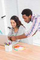 Young business people looking at a laptop