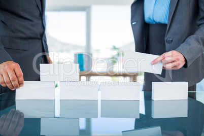 Business people stacking paper bloc