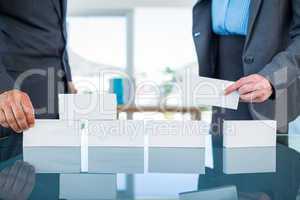 Business people stacking paper bloc