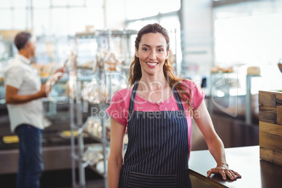 Pretty waitress leaning on counter