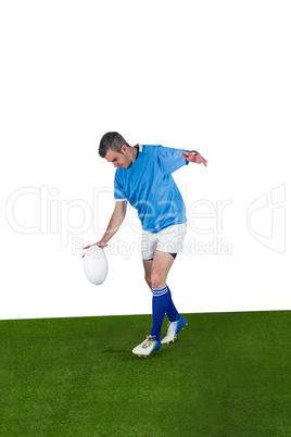 Rugby player kicking a rugby ball