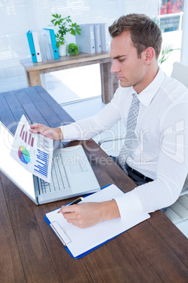 Attentive businessman working with flow charts