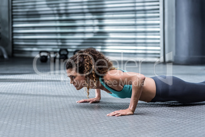 A muscular woman doing pushups