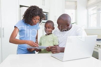 A family working and using his computer