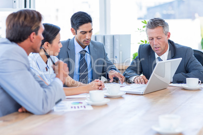 Business people speaking together during meeting