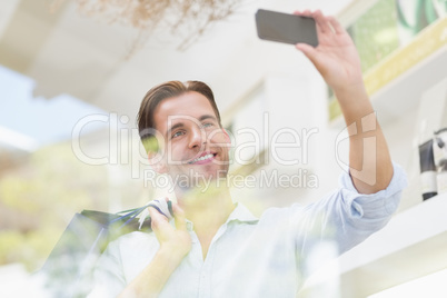 A happy smiling man taking a selfies