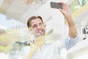 A happy smiling man taking a selfies