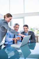 Business people looking at laptop computer