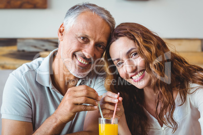 cute couple having glass of orange juice