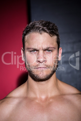 Portrait of serious muscular man looking at camera