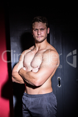 Portrait of serious muscular man looking at camera