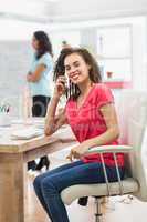 Businesswoman calling someone at her desk