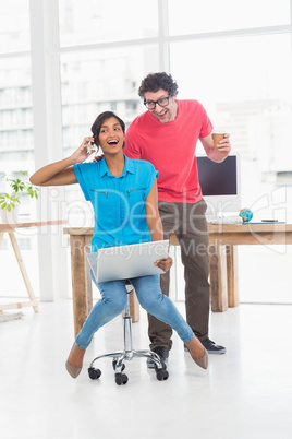 Smiling partners playing together with swivel chair