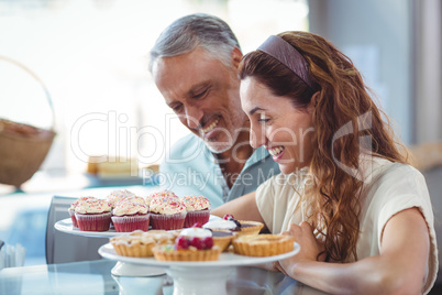 Happy couple looking at pastries