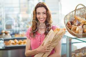 Smiling young brunette with baguettes