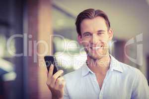 A happy smiling man looking at the phone
