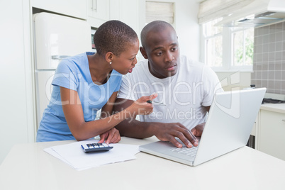 Happy couple working and using laptop