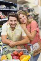 Portrait of smiling bright couple buying products