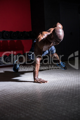 Young Bodybuilder doing One-armed push ups