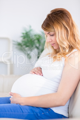 Portrait of pregnant woman with hands on belly