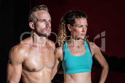 Attentive muscular couple looking away