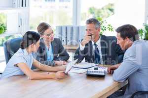 Business people speaking together during meeting