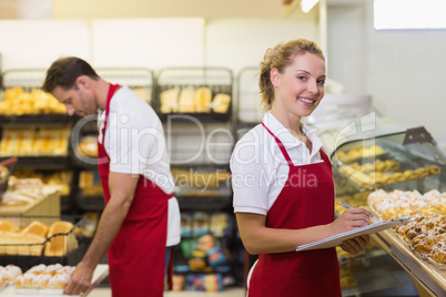 Portrait of a blonde baker with her colleague