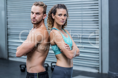 Attentive muscular couple giving back to back