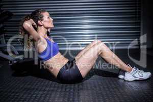 Muscular woman doing sit-ups