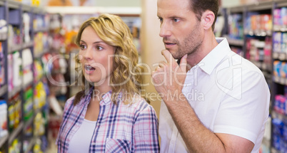 Casual couple looking at shelf