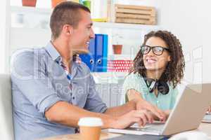 Smiling business colleagues looking at each other