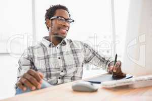 Young businessman writing on the graphic tablet