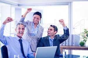 Happy business people cheering together