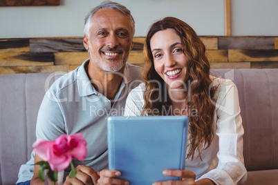 Couple using digital tablet