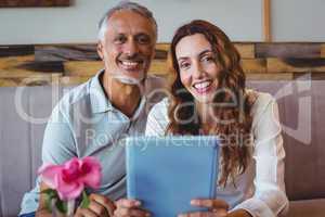 Couple using digital tablet