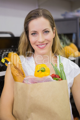 A pretty blonde with a grocery bag