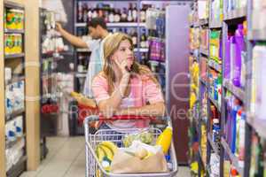 Pretty young woman looking at shelf