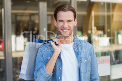 Portrait of a smiling man with shopping bags