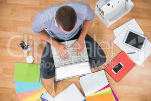 Young creative businessman working on laptop
