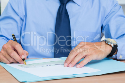 Businessman writing a contrat before signing it