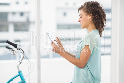 Smiling businesswoman scrolling on a digital tablet