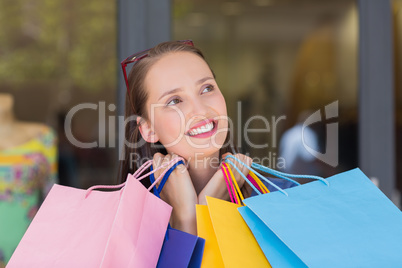 Happy woman carrying shopping bags