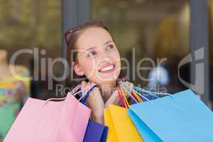 Happy woman carrying shopping bags