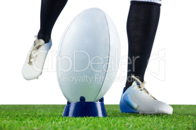 Rugby player doing a drop kick